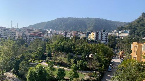 a view of a city with trees and buildings at Luxury Aloha Majestic Apartments in Rishīkesh