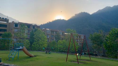 a playground with a slide and a slideintend at Luxury Aloha Majestic Apartments in Rishīkesh