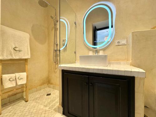 a bathroom with a sink and a mirror at Riad Belharra in Marrakech