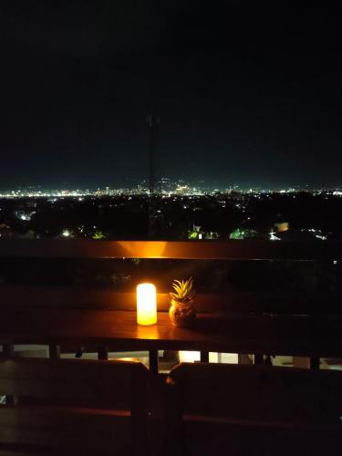 a candle sitting on top of a table at night at Stefan's Cozy Place in Agus