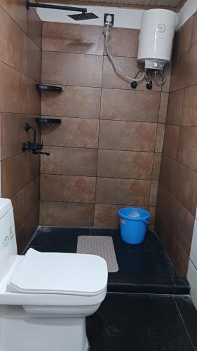 a bathroom with a toilet and a shower at Lotus Homestay in Darjeeling
