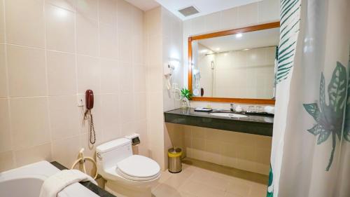 a bathroom with a toilet and a sink and a phone at Sai Gon Rach Gia Hotel in Rach Gia