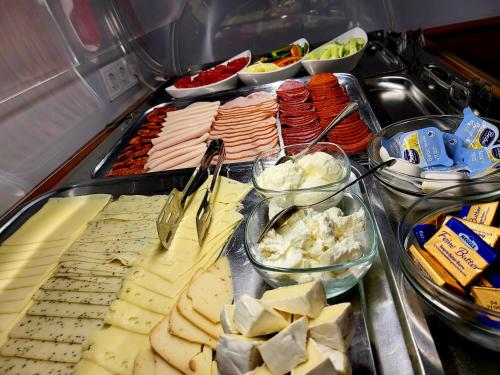a buffet with many different types of meats and vegetables at Gizella Hotel and Restaurant in Veszprém