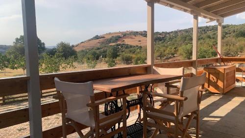 a wooden table and chairs on a porch with a view at HEAVEN HOUSE in Kavala