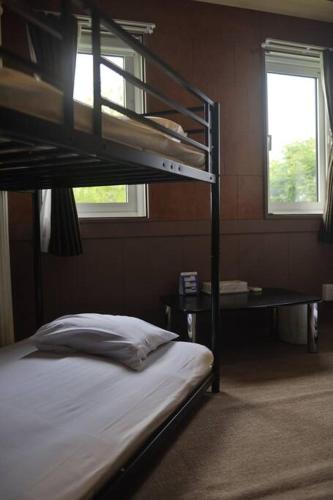 a bedroom with a bunk bed and a window at Starry Sky Cottage 15 in Kitami