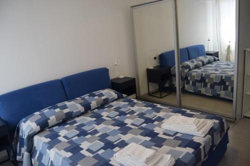 a room with two beds and a mirror at B&B We CaRe Appartamento in Lendinara