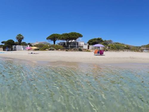 vista sulla spiaggia dall'acqua di Villa Gialla IUN Q5511 a Pula