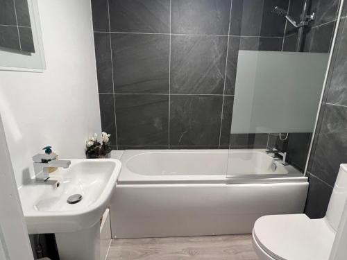 a bathroom with a white tub and a sink at Ranmoor Serviced Apartments at Victoria Quays in Sheffield