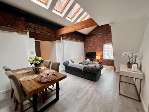 a living room with a table and a couch at Ranmoor Serviced Apartments at Victoria Quays in Sheffield