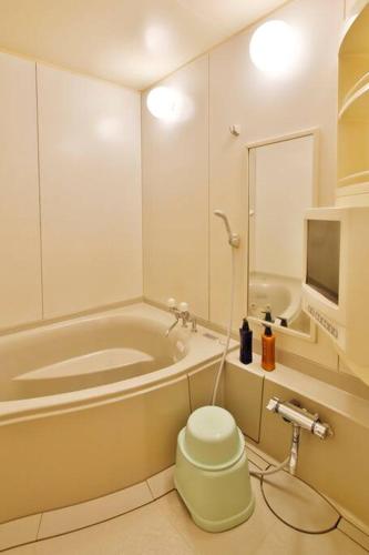 a bathroom with a tub and a toilet and a tv at Starry Sky Cottage 16 in Bihoro
