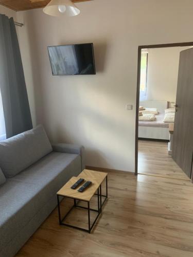 a living room with a couch and a coffee table at Pension Formanka in Splzov