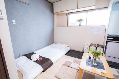 a small room with a bed and a table at Toko inn courtyard in Tokyo
