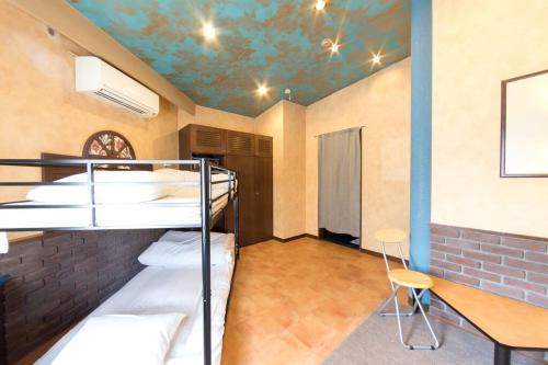 a room with two bunk beds and a table at Starry Sky Cottage 17 in Bihoro