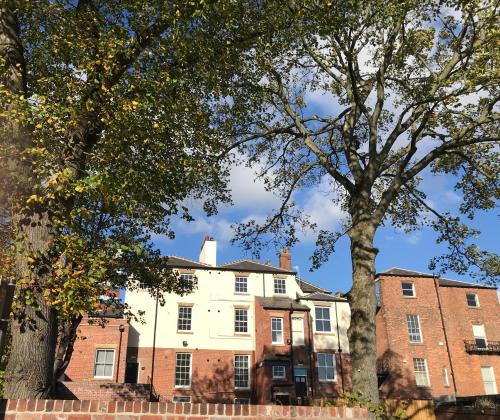 an old building with trees in front of it at The Glossop Suite in Sheffield