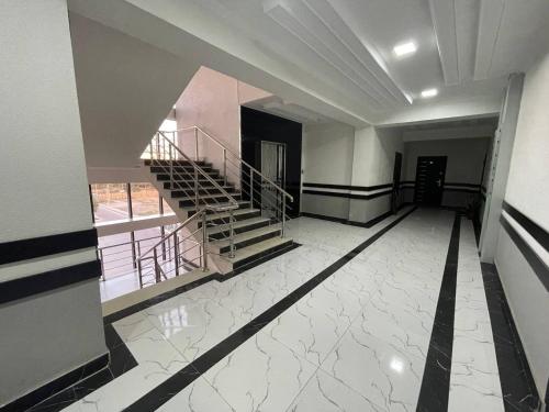 an empty room with stairs in a building at Harmony Homestay in Samarkand