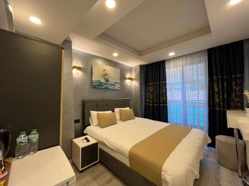 a bedroom with a large bed and a window at White Palace Haliç in Istanbul