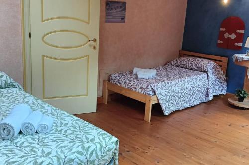 a room with two beds and a door at Lago di Sole X 6 Point Break in Marone