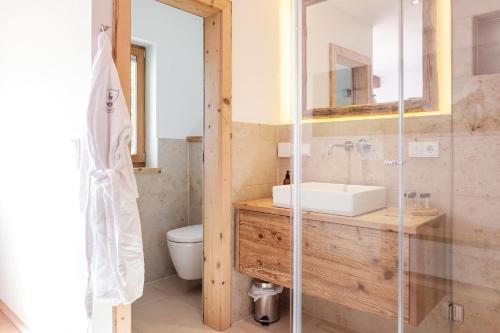 a bathroom with a sink and a toilet at Design Suite Maximilian Tegernsee - Das Alpbach in Tegernsee