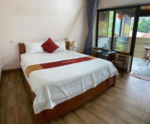 a bedroom with a large bed with a large window at Tam Coc Westlake Homestay in Ninh Binh