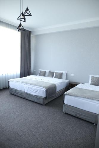 Un ou plusieurs lits dans un hébergement de l'établissement BMG Hotel by Grigoryans Group