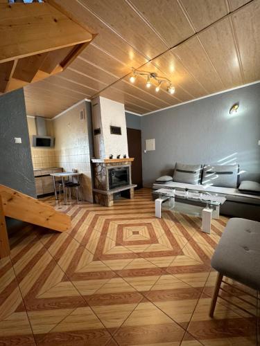 a large living room with a couch and a table at Domki u Marka in Polańczyk