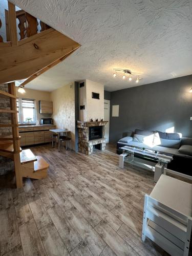 a large living room with a couch and a table at Domki u Marka in Polańczyk