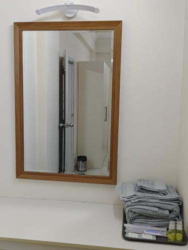 a mirror on a wall above a bathroom sink at Best 3BHK Premium Homestay - Onyx, 7 Elysee Homestay in Trichūr