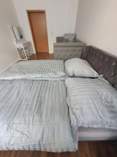 an unmade bed in a bedroom with a bed frame at Eigentumswohnung in Dresden in Dresden