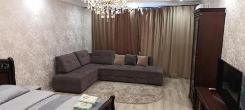 a living room with a couch and a television at HotelRoom 21 in Uzhhorod