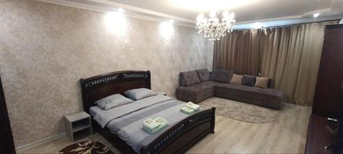 a bedroom with a bed and a couch at HotelRoom 21 in Uzhhorod