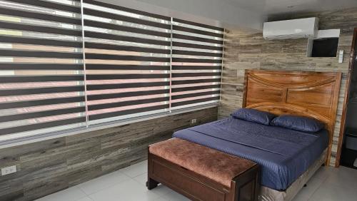 a bedroom with a bed and a wooden wall at Lydia's House in Kaputian