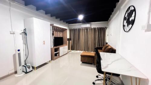 sala de estar con reloj en la pared en uouRangnamHouse, en Bangkok