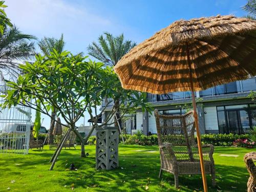 a chair and an umbrella and a swing at Villa Ten - Veg out in Guilin