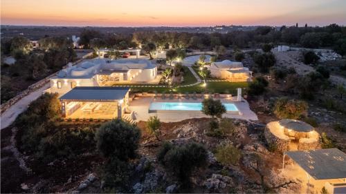 an aerial view of a house with a swimming pool at Tenuta PANORAMICAPULIA - Luxury Masseria Ostuni in Ostuni
