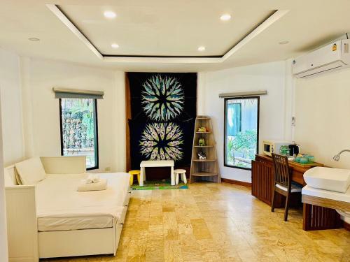 a living room with a bed and a desk at Twin Bay Resort Koh Lanta in Ko Lanta