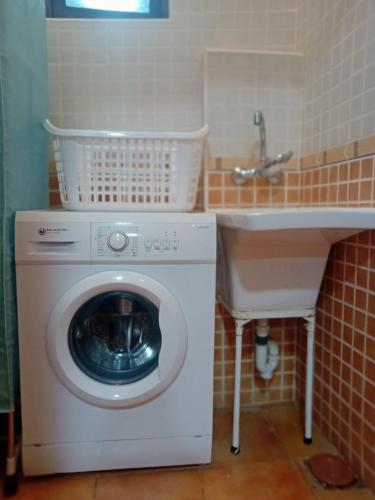 a washing machine in a bathroom next to a sink at Apartamento El Cortijo in Mojácar