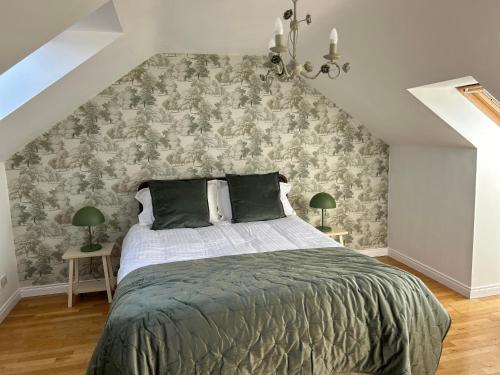a bedroom with a large bed with a wall at Belfast Skyline Retreat - 3 Bedroom Apartment with Free Parking in Belfast