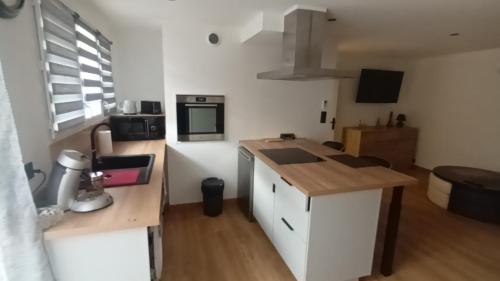 une petite cuisine avec un comptoir et un micro-ondes dans l'établissement Appartement calme, à Salses-le-Chateau