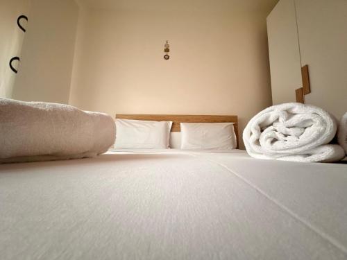 a bed with white sheets and towels on it at Casa Gena in Favaro Veneto