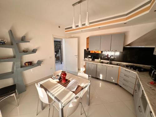 a kitchen with a white table and white chairs at Casa Gena in Favaro Veneto