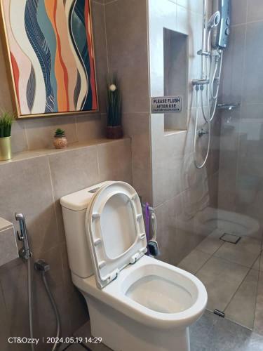 a bathroom with a toilet with the seat up at Timurbay Seafront Residence By Ozzy Azizi in Kuantan
