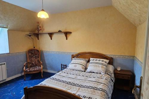 a bedroom with a bed with pillows on it at La Maison Bricquebetaise in Bricquebec