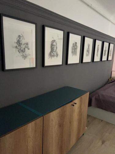a room with a counter with drawings on the wall at Graffiti Downtown Room in Szeged
