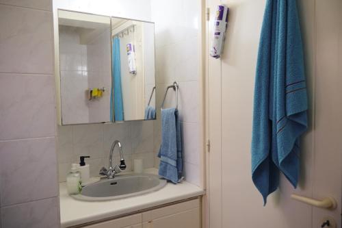 a bathroom with a sink and a mirror at Soleil Residence, near Konnos Beach in Protaras