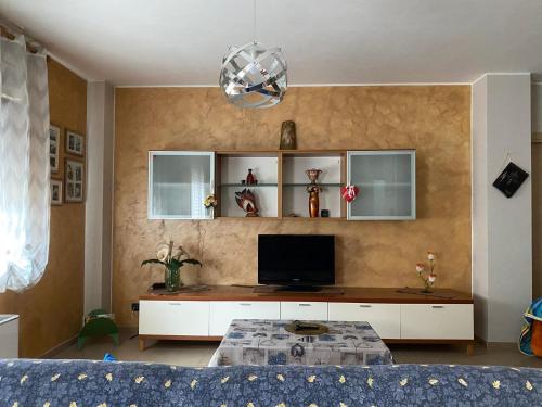a living room with a tv on a wall at La dimora dei Sanniti in Busso