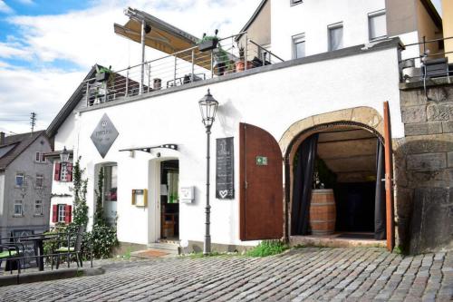 a white building with an archway on a street at Doppelzimmer in der Altstadt in Nürtingen