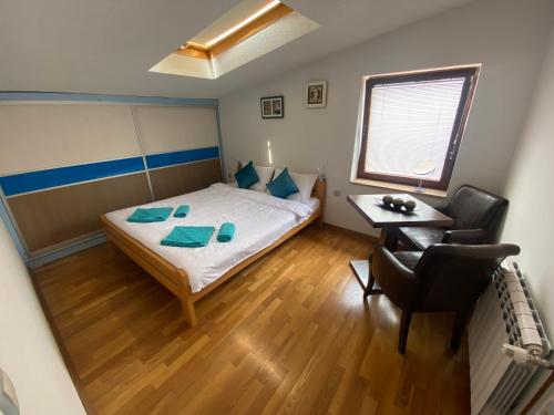 a bedroom with a bed and a desk and a chair at Apartments NOVEL town square in Ohrid