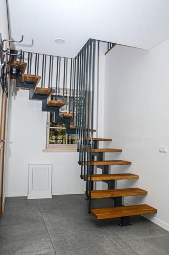 a spiral staircase in a room with a window at Rami erdvė šalia miško ir ežero darbui ir poilsiui in Trakai