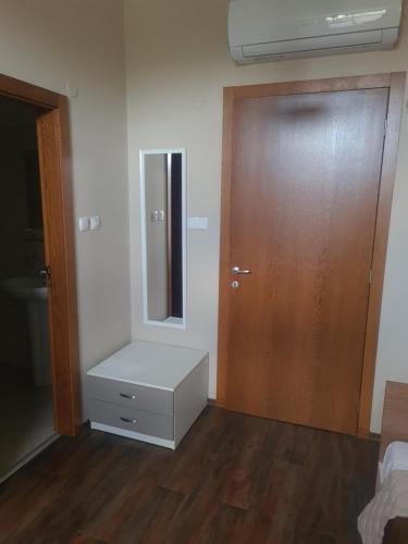 a room with a door and a dresser and a mirror at Balkan Aparts in Hisarya