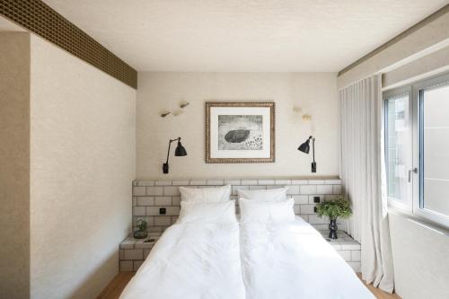 two white beds in a bedroom with a window at B5 Boutique & Design Hotel - Digital Check in - Adults Only in Lugano